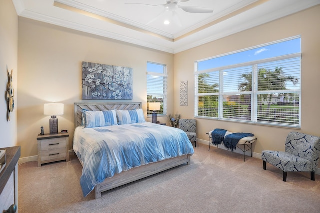 carpeted bedroom featuring crown molding, ceiling fan, and a tray ceiling