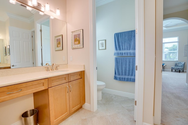 bathroom featuring crown molding, vanity, and toilet