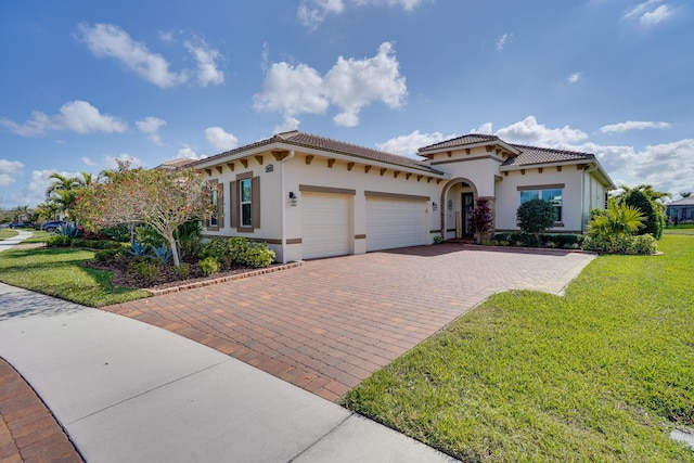 mediterranean / spanish-style house featuring a garage and a front yard