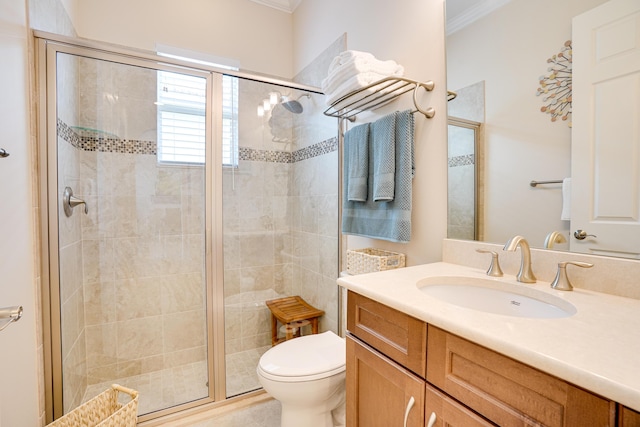 bathroom with ornamental molding, walk in shower, vanity, and toilet