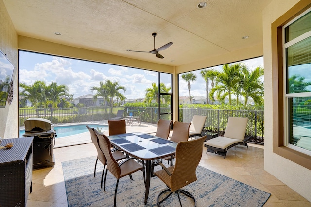 sunroom / solarium featuring ceiling fan