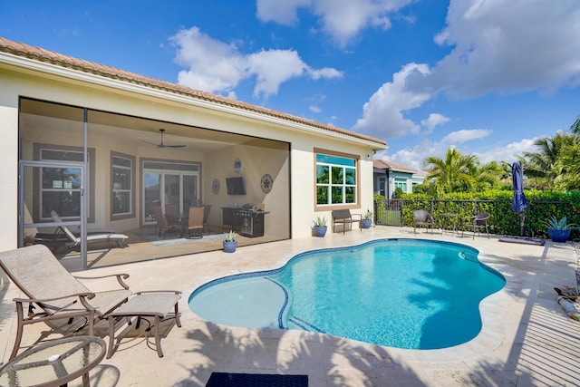 view of swimming pool with ceiling fan and a patio area