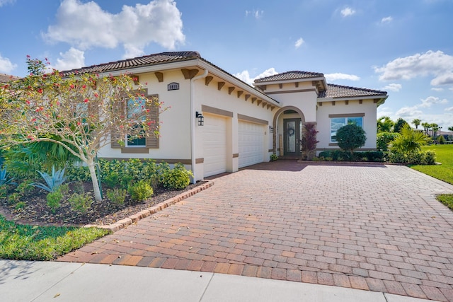 mediterranean / spanish-style home featuring a garage