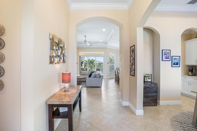 hall with ornamental molding and light tile patterned flooring