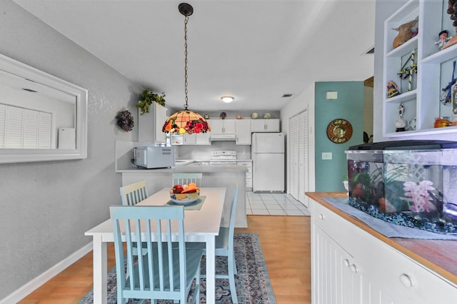 dining space with light hardwood / wood-style floors