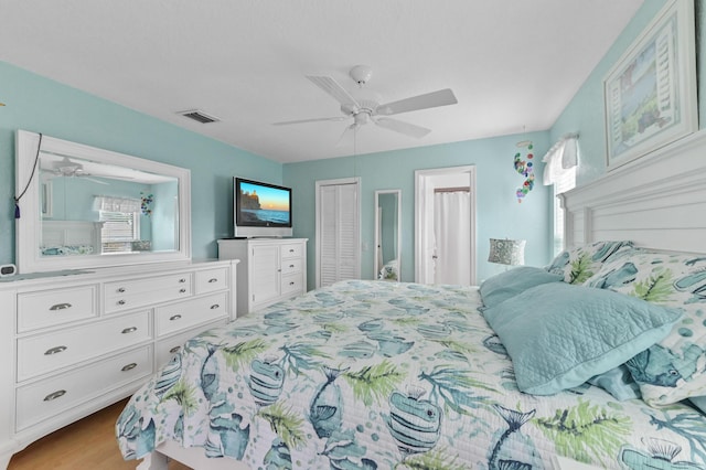 bedroom with light hardwood / wood-style flooring, a closet, and ceiling fan