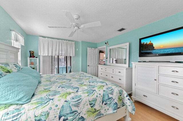 bedroom featuring ceiling fan, access to outside, and light wood-type flooring