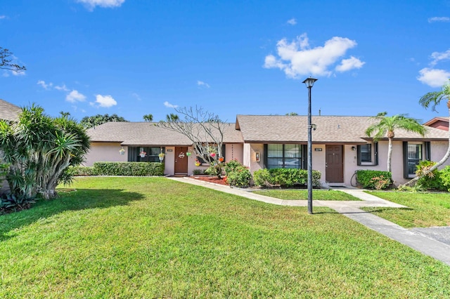 ranch-style home featuring a front lawn