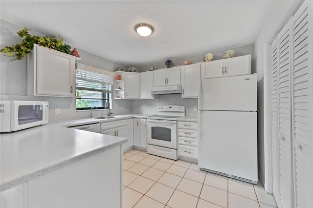 kitchen featuring sink, a textured ceiling, white cabinets, and white appliances