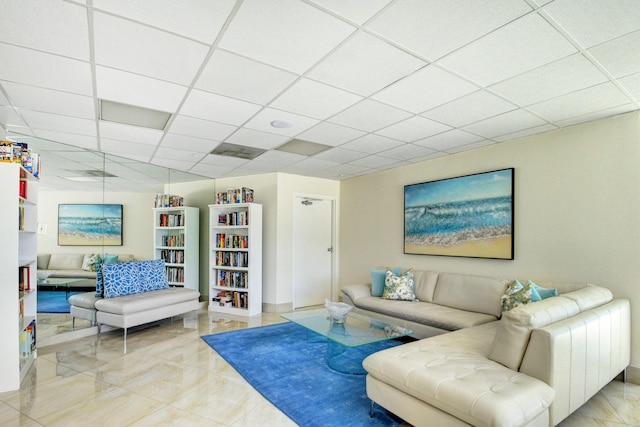 living room featuring a paneled ceiling