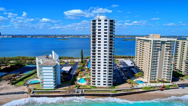 drone / aerial view featuring a water view and a beach view