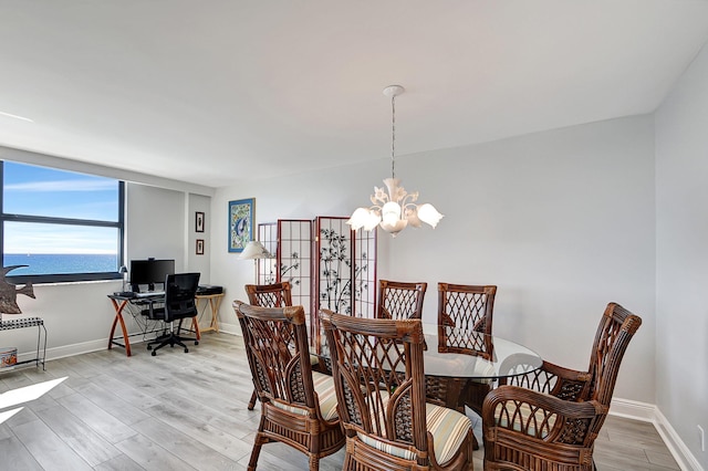 dining area featuring a chandelier and light hardwood / wood-style floors