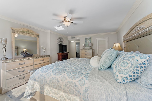 bedroom with ornamental molding and ceiling fan