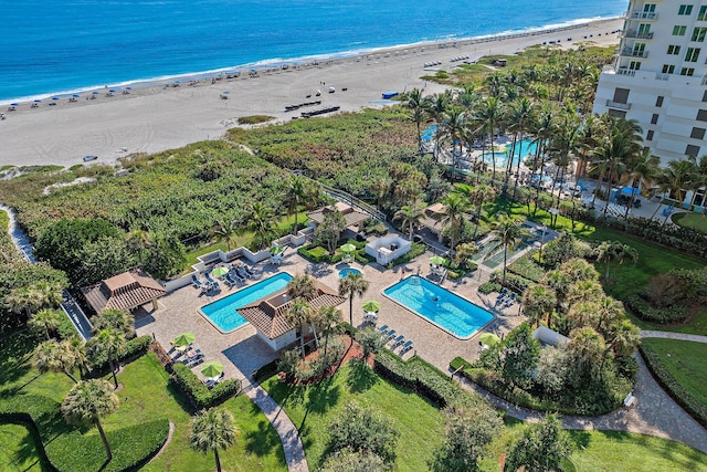 aerial view with a water view and a beach view