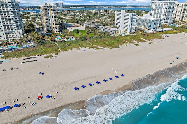 bird's eye view with a water view and a beach view