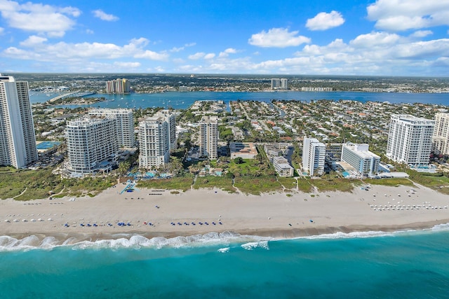 bird's eye view featuring a water view and a beach view