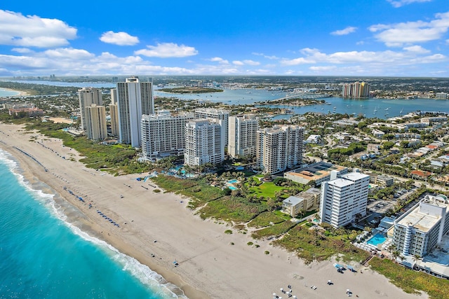 bird's eye view featuring a water view and a beach view