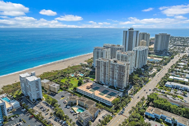 bird's eye view featuring a water view and a beach view