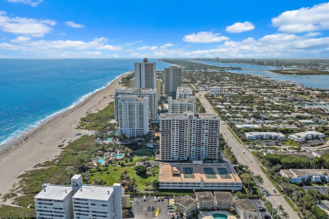 birds eye view of property featuring a beach view and a water view