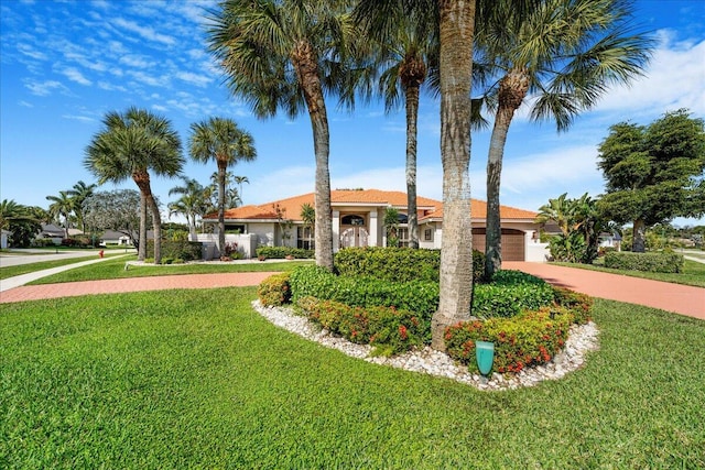 view of front facade with a garage and a front yard