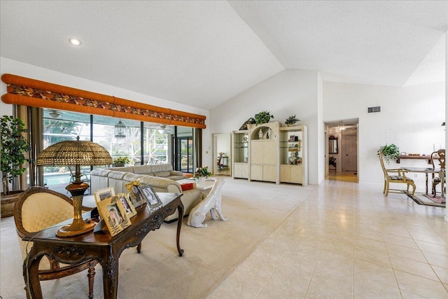 living room featuring light tile patterned floors and high vaulted ceiling