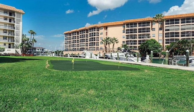 2871 N Ocean Blvd Unit F427, Boca Raton, FL 33431 - view of community featuring an area to practice putting and a lawn