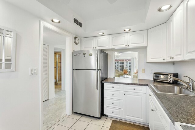 2871 N Ocean Blvd Unit F427, Boca Raton, FL 33431 - kitchen featuring freestanding refrigerator, a sink, recessed lighting, dark countertops, and white cabinets