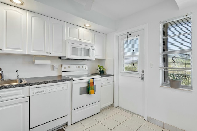 2871 N Ocean Blvd Unit F427, Boca Raton, FL 33431 - kitchen with white appliances, a sink, dark countertops, and light tile patterned flooring