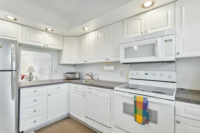 2871 N Ocean Blvd Unit F427, Boca Raton, FL 33431 - kitchen featuring white appliances, a sink, recessed lighting, dark countertops, and white cabinets