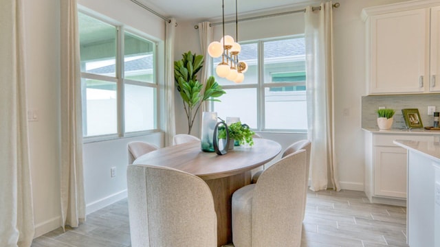 dining room with plenty of natural light and a notable chandelier