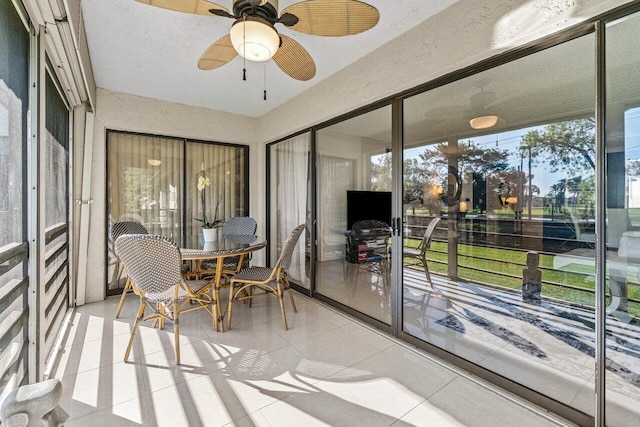 sunroom / solarium featuring ceiling fan