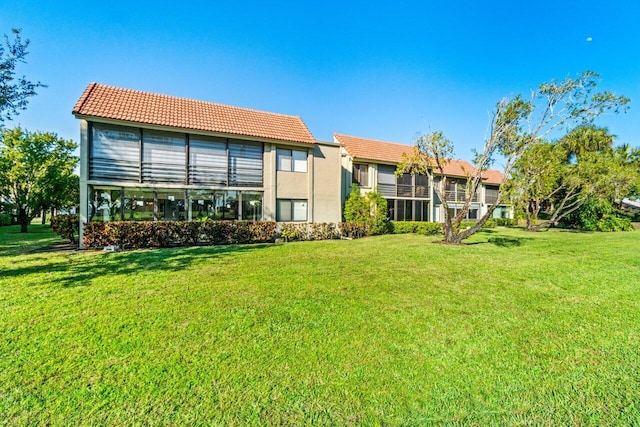 rear view of house with a yard