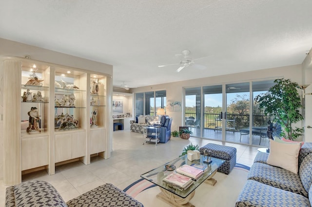 tiled living room with ceiling fan and a textured ceiling