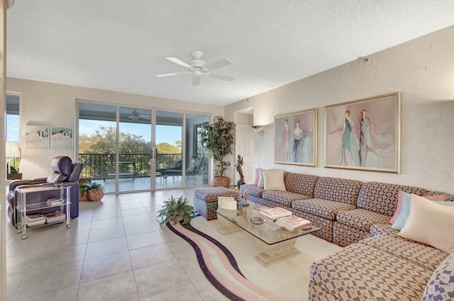 living room with ceiling fan, a textured ceiling, and light tile patterned floors