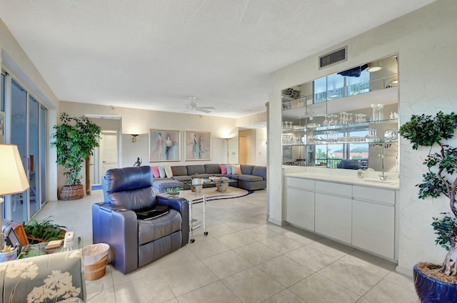 tiled living room with ceiling fan