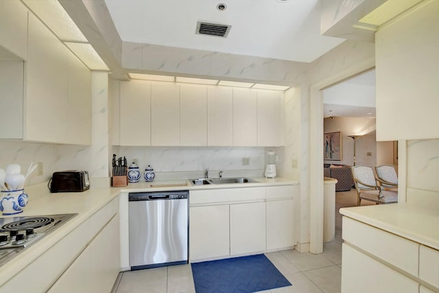 kitchen with white stovetop, light tile patterned flooring, sink, dishwasher, and decorative backsplash