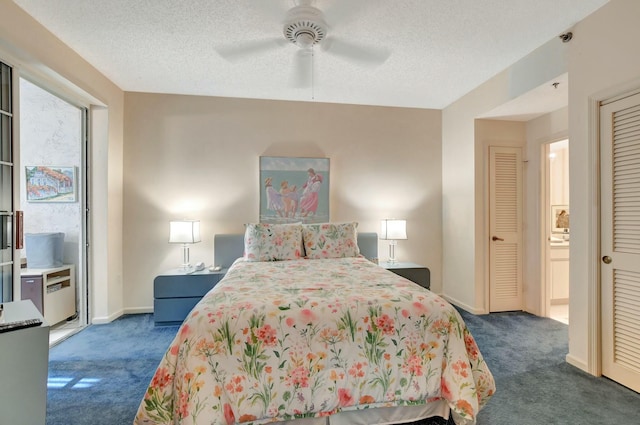 carpeted bedroom featuring ceiling fan and a textured ceiling