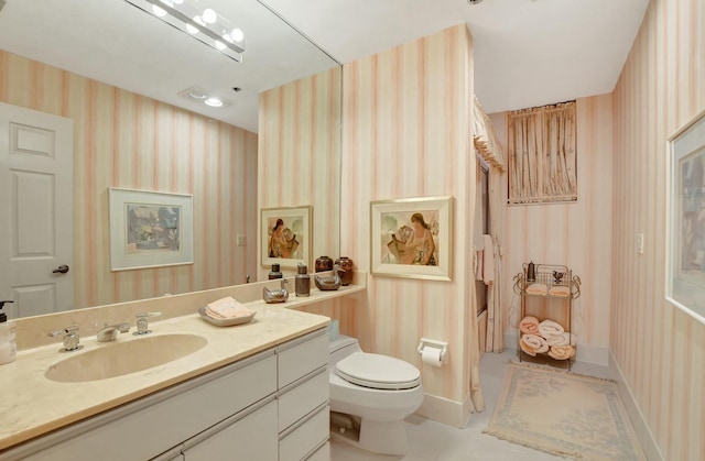 bathroom featuring vanity and toilet