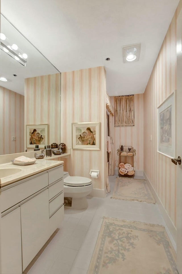 bathroom with vanity, tile patterned floors, and toilet