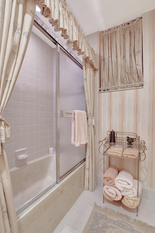 bathroom featuring tile patterned floors and combined bath / shower with glass door