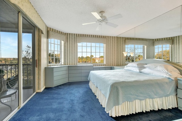 carpeted bedroom featuring ceiling fan, access to exterior, and a textured ceiling