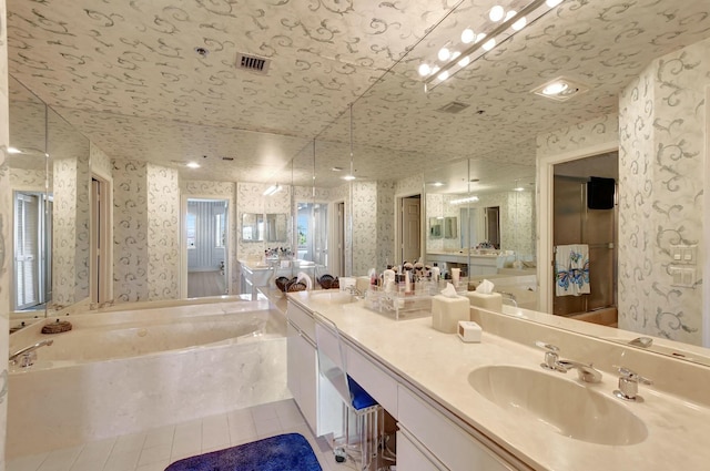 bathroom featuring vanity, tile patterned flooring, and a bathtub