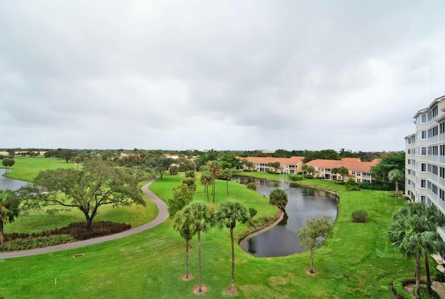 surrounding community with a yard and a water view