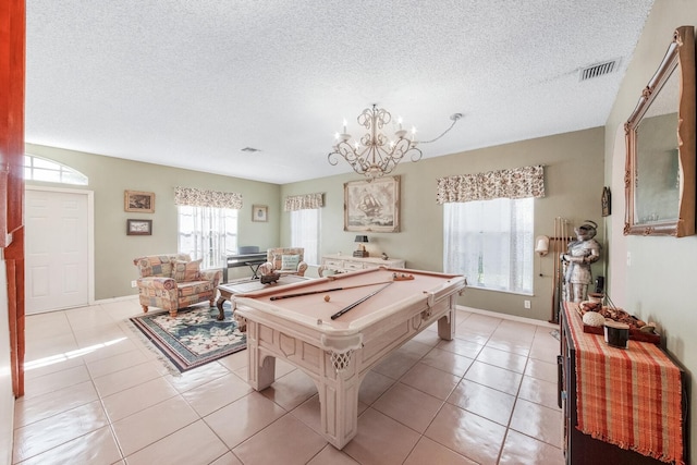 recreation room with light tile patterned flooring, a chandelier, a textured ceiling, and billiards