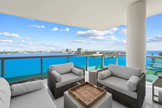 balcony featuring a water view and an outdoor hangout area