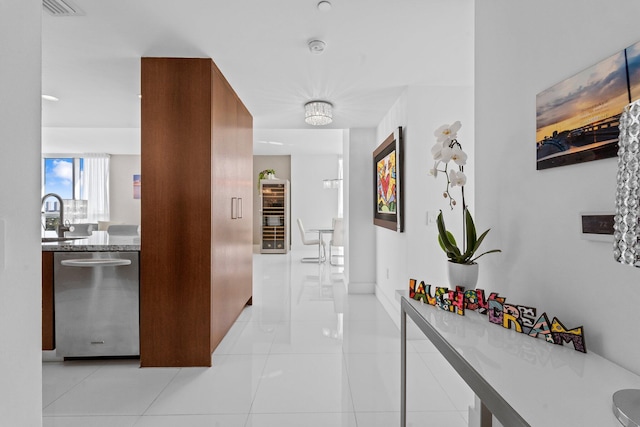 hallway with sink and light tile patterned floors