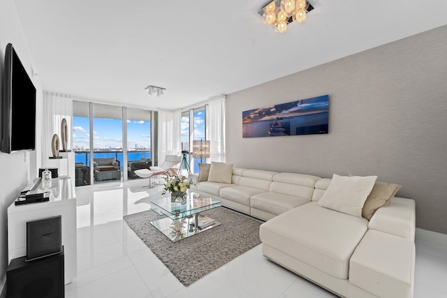 living room with a water view and a wall of windows