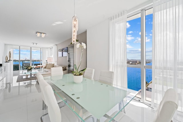 kitchen with white cabinetry, light stone counters, tasteful backsplash, and a center island with sink