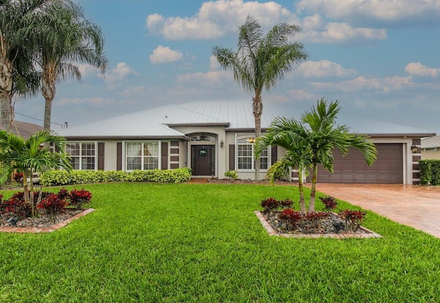 ranch-style house with a garage and a front lawn