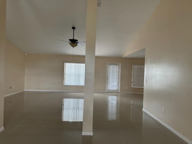 tiled spare room with ceiling fan